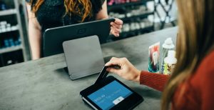 A woman using Klarna to buy things in a shop
