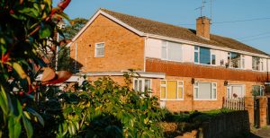 Brick houses with green bushes and clear blue sky