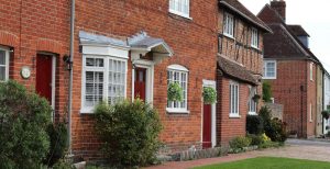 A row of traditional brick houses with red doors