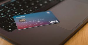 Credit card sitting on top of a laptop