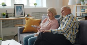 Couple aged 50+ watching TV together