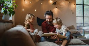 A dad reading to his two children