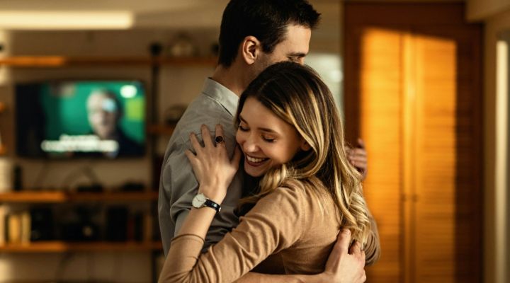 Young couple hugging each other in the living room