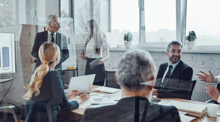 Business owners giving a presentation in a board room meeting