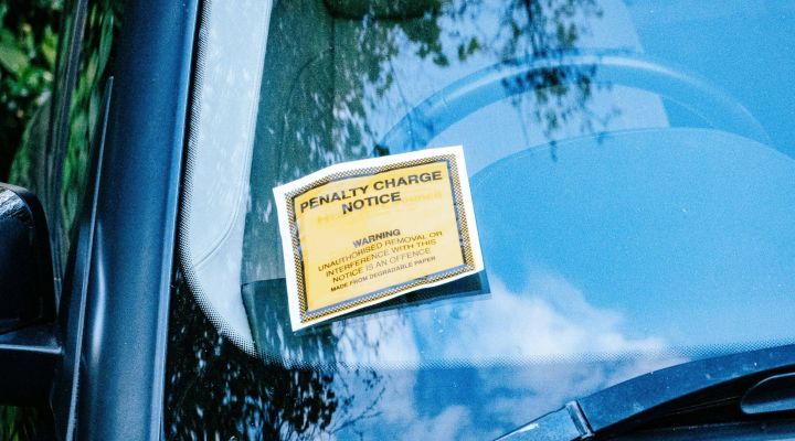 A car with a parking ticket on its