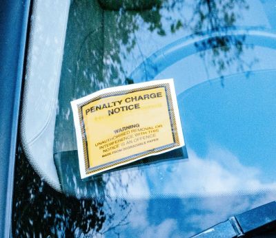 A car with a parking ticket on its