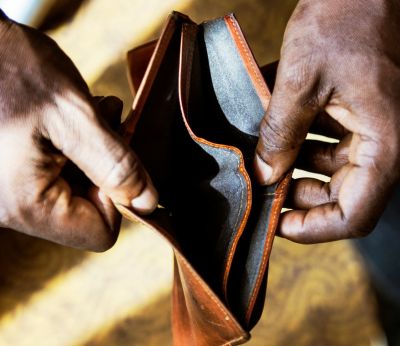 A person opening an empty wallet
