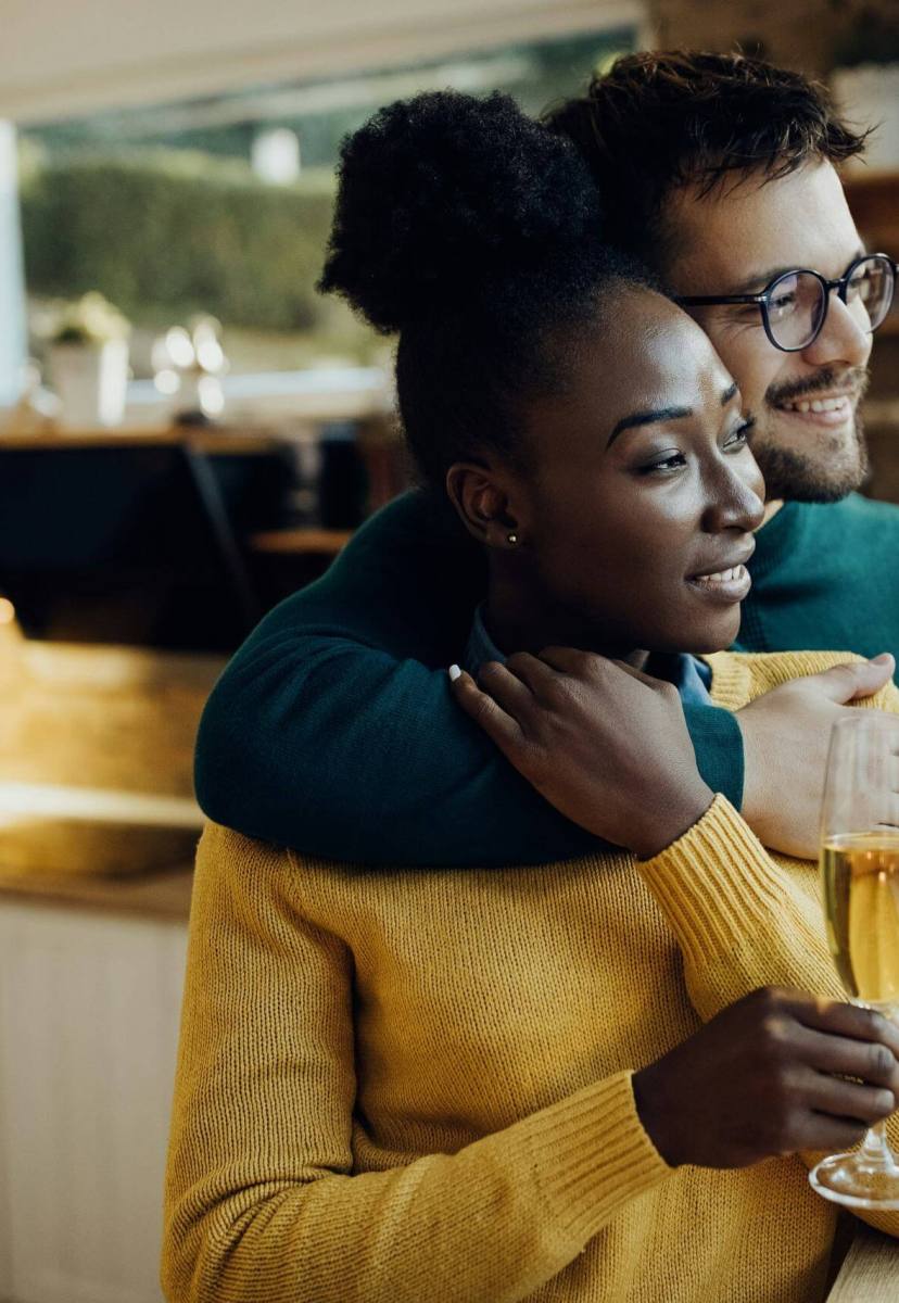 A couple drinking champagne in their new home after securing a mortgage with a mortgage advisor