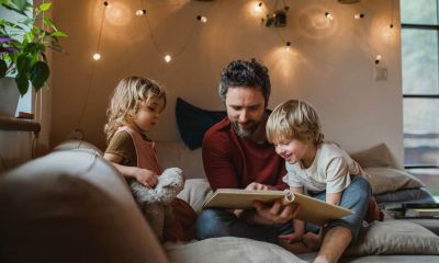 A dad reading to his two children